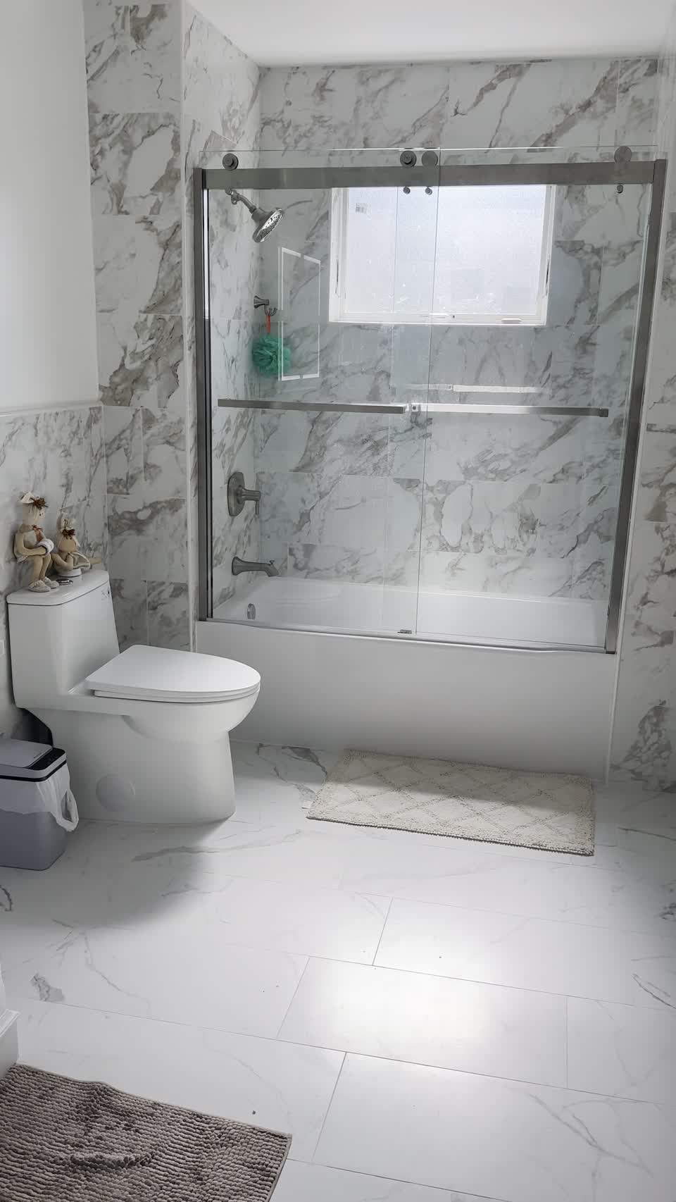 Finished bathroom renovation with tiled shower and modern fixtures by Dakis Contracting Inc.