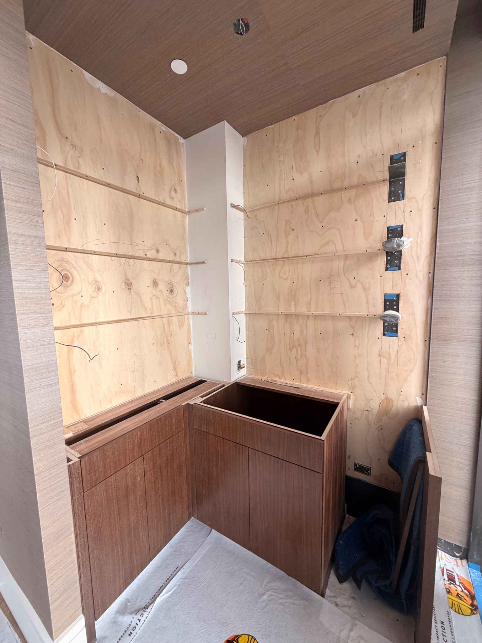 Custom bar area under construction with cabinetry and wall backing