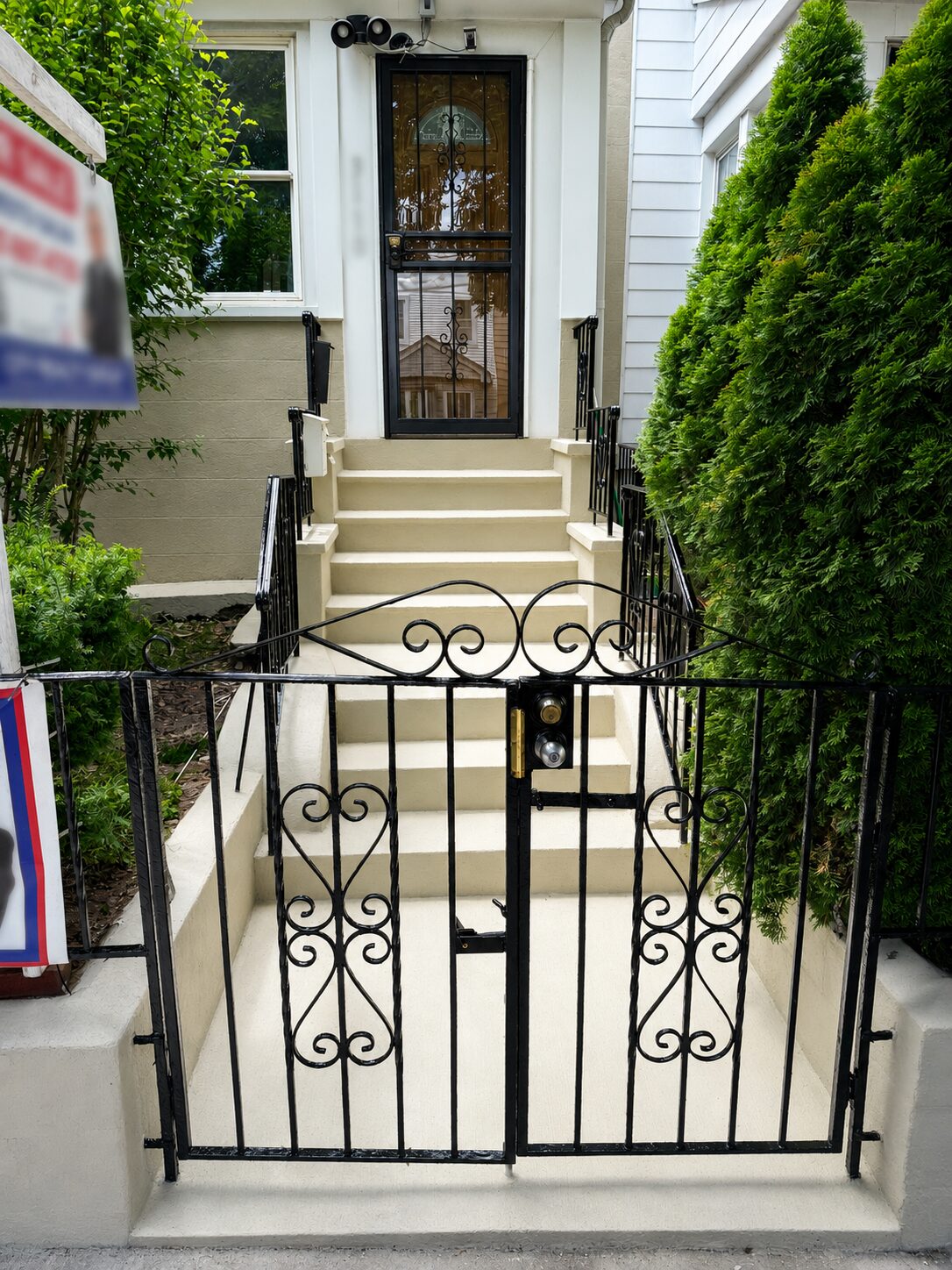 Completed front entry with refreshed concrete steps and painted metal gate
