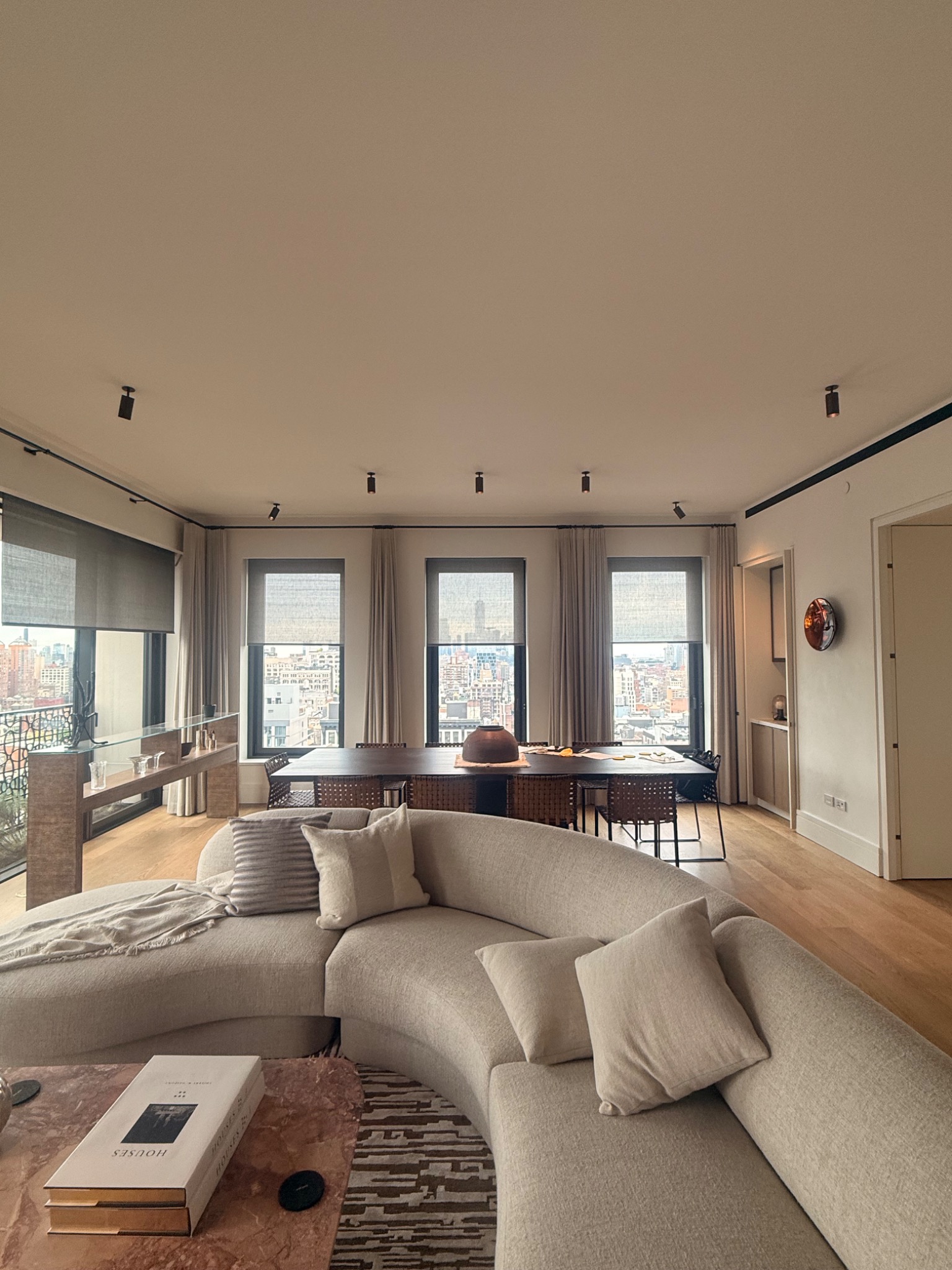 Finished Manhattan living room with recessed lighting and city views